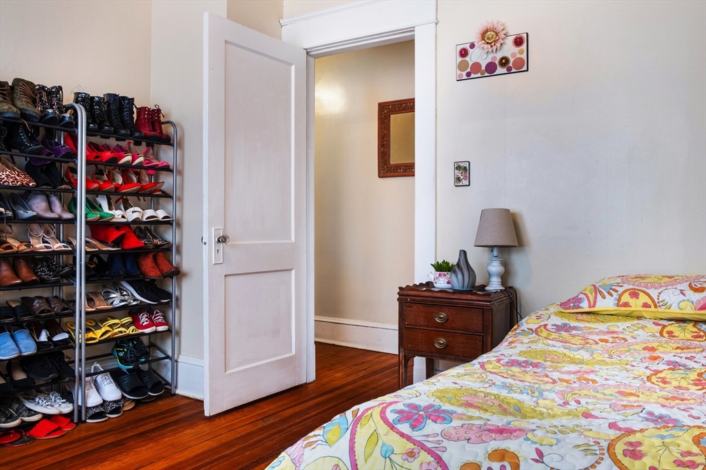 39 Meredith Street Springfield, MA 01108 - Photo 17 of 36 a bedroom with a bed and wooden floor