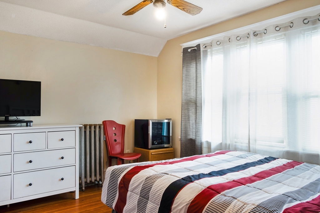 39 Meredith Street Springfield, MA 01108 - Photo 26 of 36 a bedroom with a bed and a flat screen tv