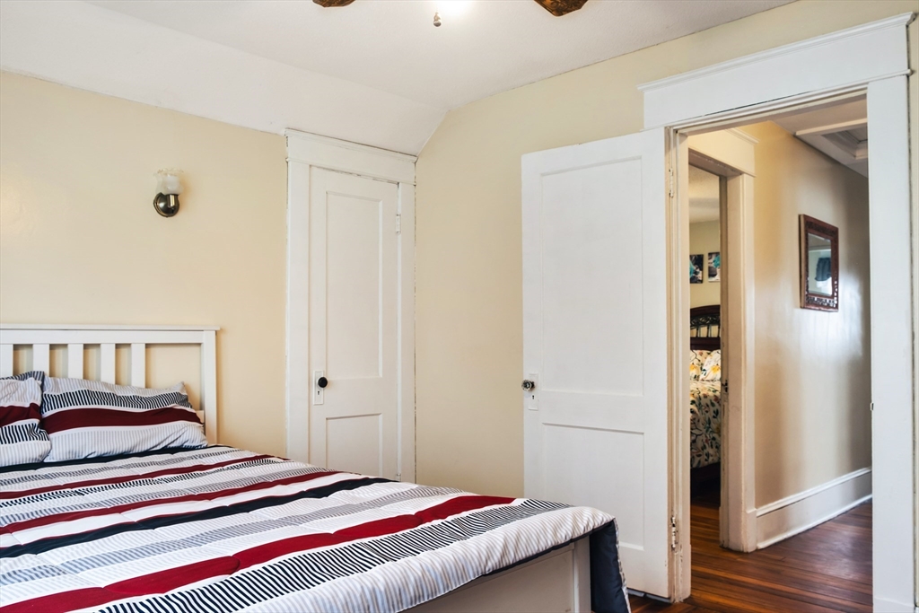 39 Meredith Street Springfield, MA 01108 - Photo 27 of 36 a bedroom with a bed and wooden floor