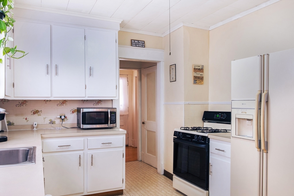 39 Meredith Street Springfield, MA 01108 - Photo 10 of 36 a kitchen with stainless steel appliances a stove microwave and refrigerator