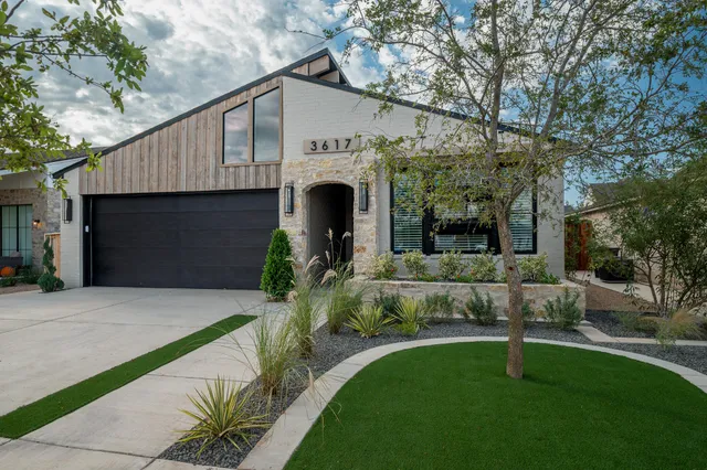 a front view of a house with a garden