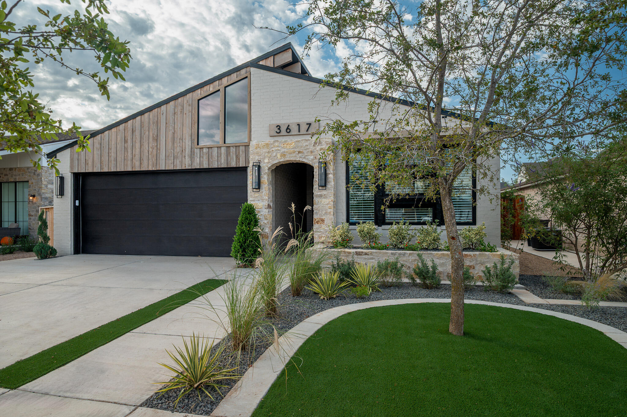 a front view of a house with a garden