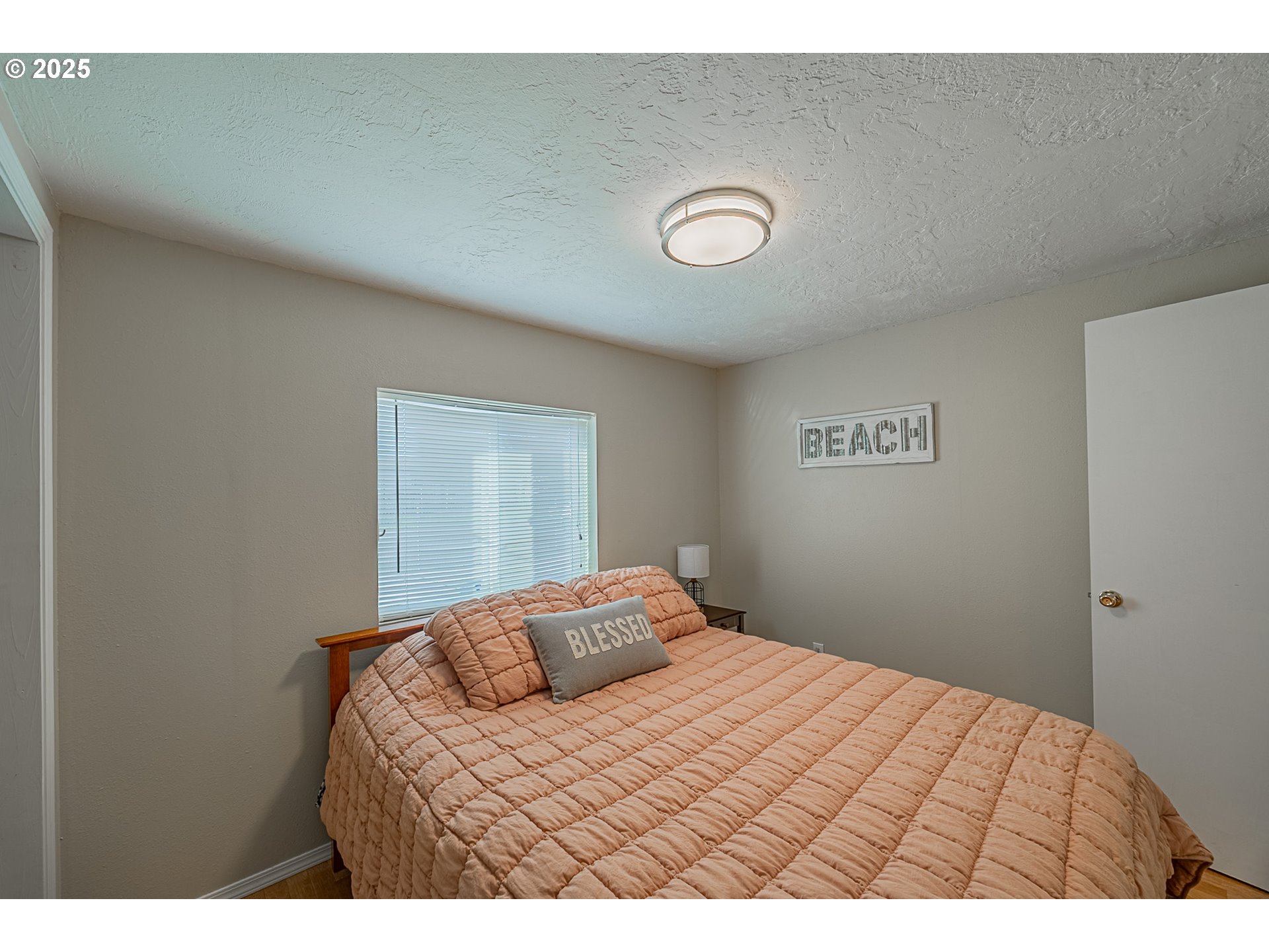 150 North 11th Street Lakeside, OR 97449 - Photo 23 of 37 a bedroom with a bed and a window