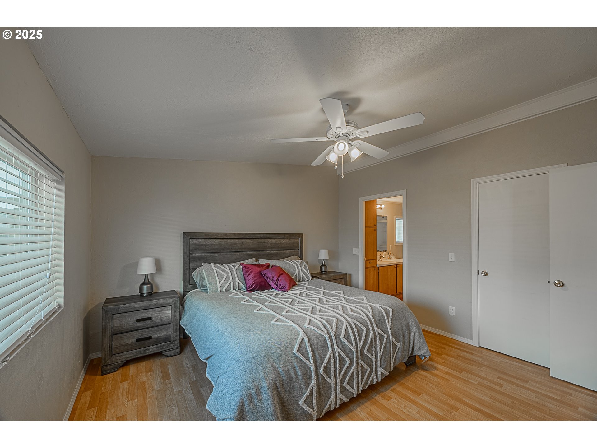 150 North 11th Street Lakeside, OR 97449 - Photo 26 of 37 a bedroom with a bed and a chandelier
