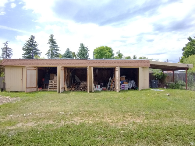 157 West 500 South Logan, UT 84321 - Photo 12 of 38 Multi-bay outbuilding with a shingle roof and an attached covered carport