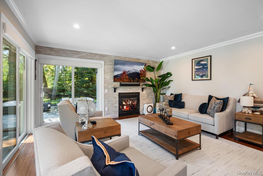 5 Coon Hollow Road Lloyd Harbor, NY 11743 - Photo 12 of 43 a living room with furniture fireplace and a large window