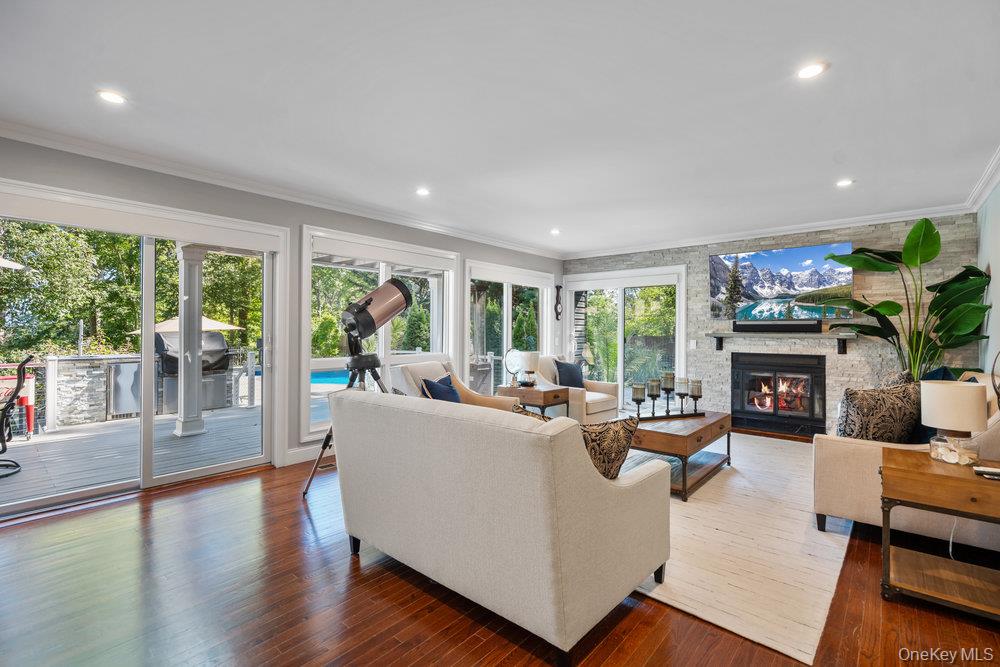 5 Coon Hollow Road Lloyd Harbor, NY 11743 - Photo 13 of 43 a living room with fireplace furniture and a large window