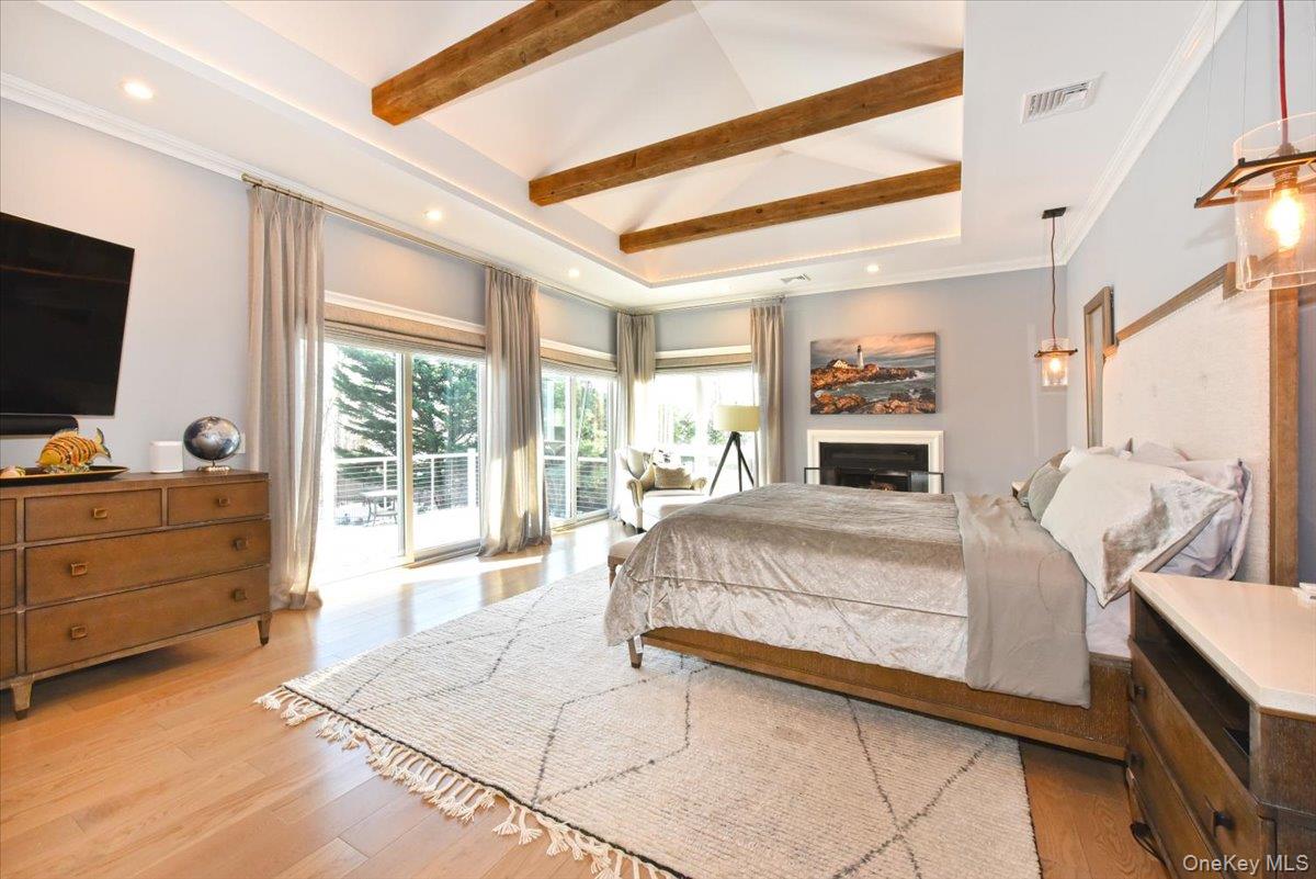 5 Coon Hollow Road Lloyd Harbor, NY 11743 - Photo 17 of 43 a spacious bedroom with a large bed and a flat tv screen