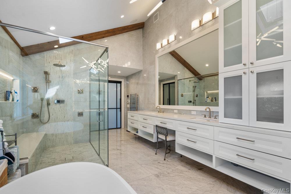 5 Coon Hollow Road Lloyd Harbor, NY 11743 - Photo 19 of 43 a bathroom with a tub sink shower and mirror