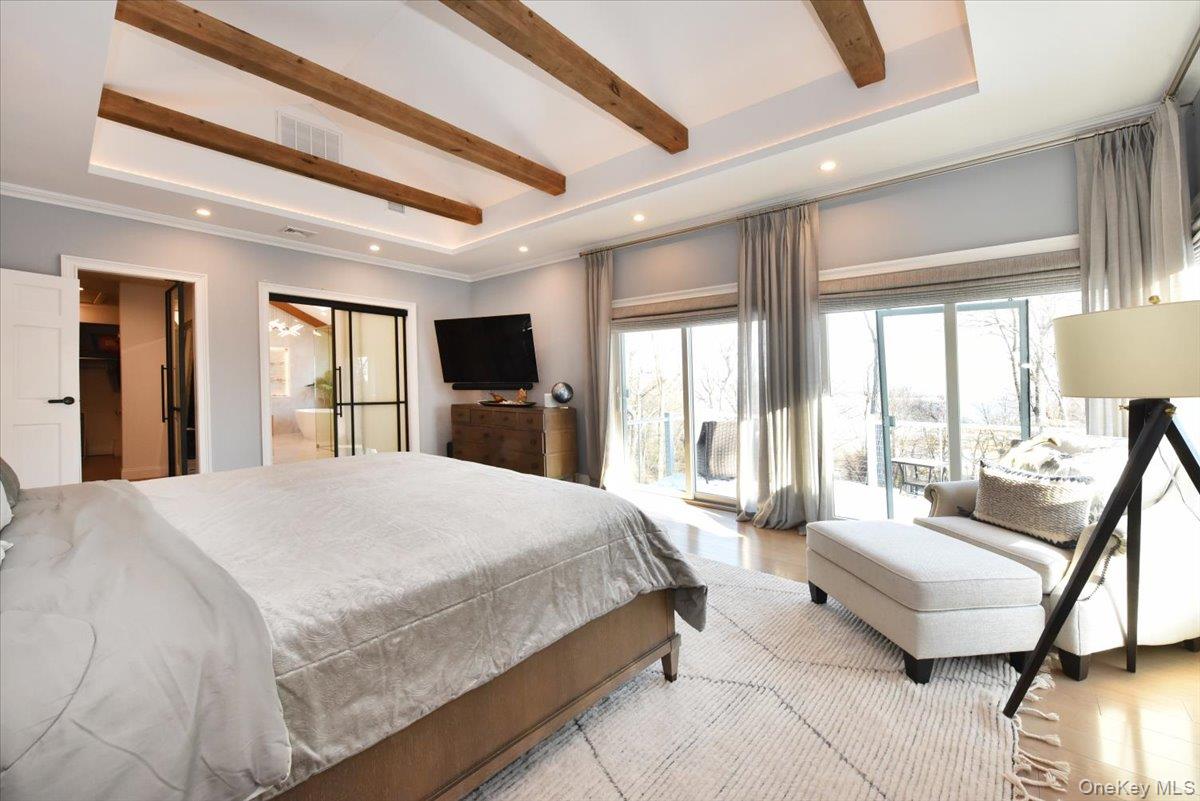 5 Coon Hollow Road Lloyd Harbor, NY 11743 - Photo 21 of 43 a spacious bedroom with a large bed and a couch