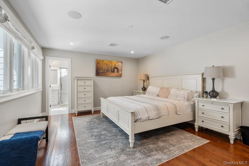 5 Coon Hollow Road Lloyd Harbor, NY 11743 - Photo 22 of 43 a bedroom with a bed and a night stand