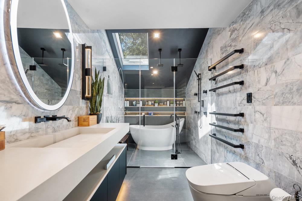 5 Coon Hollow Road Lloyd Harbor, NY 11743 - Photo 26 of 43 a bathroom with a toilet sink and mirror