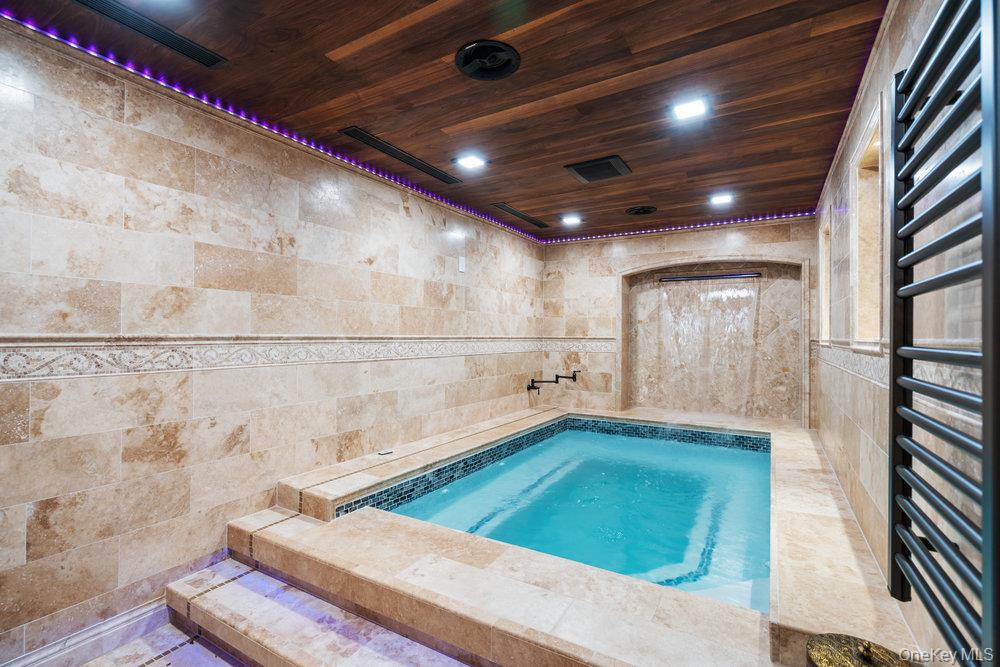 5 Coon Hollow Road Lloyd Harbor, NY 11743 - Photo 28 of 43 a bathroom with a tub and shower