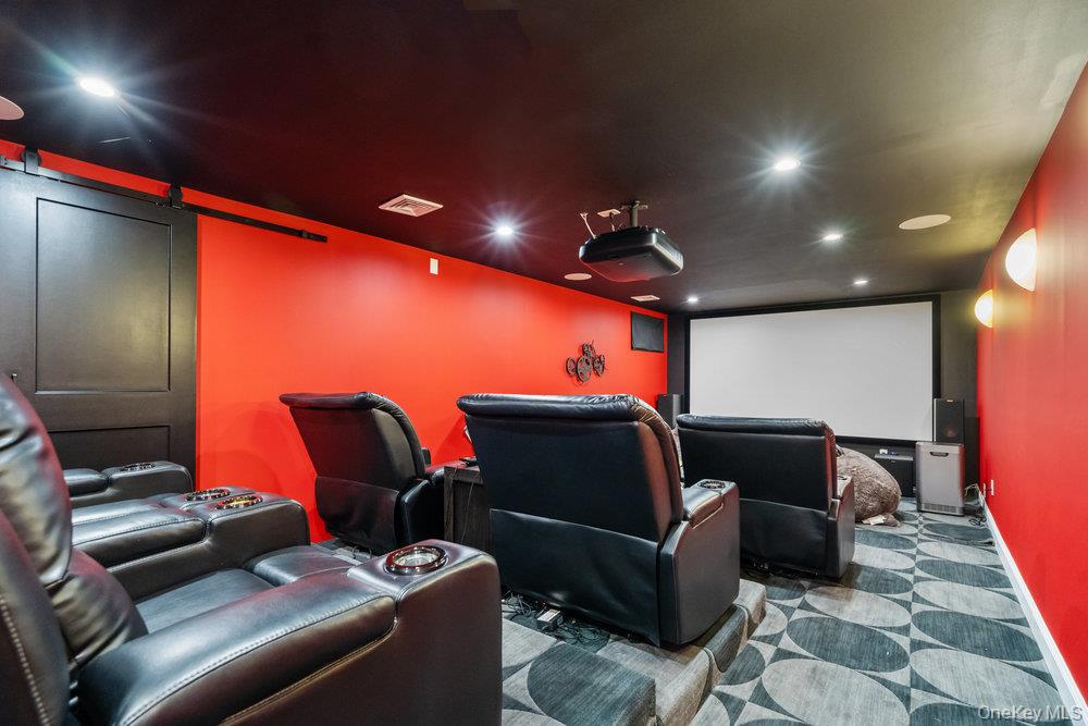 5 Coon Hollow Road Lloyd Harbor, NY 11743 - Photo 33 of 43 a media room with lots of chairs and a projector screen