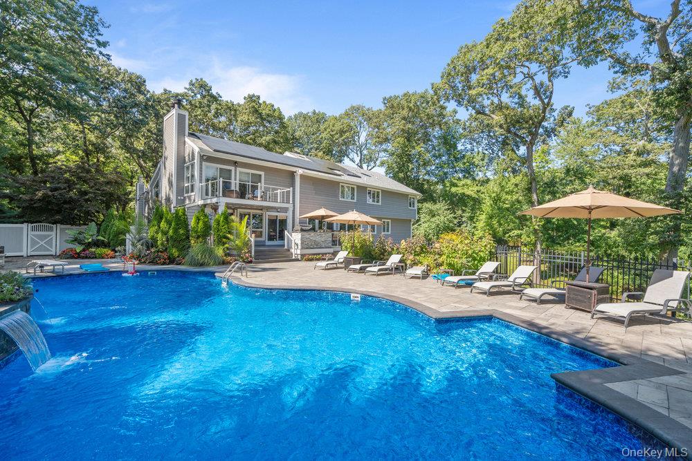 5 Coon Hollow Road Lloyd Harbor, NY 11743 - Photo 36 of 43 a view of a house with swimming pool and sitting area