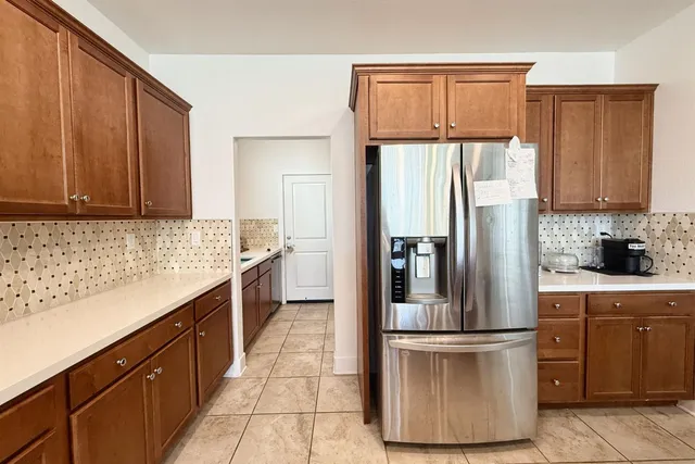 a kitchen with a refrigerator sink and microwave