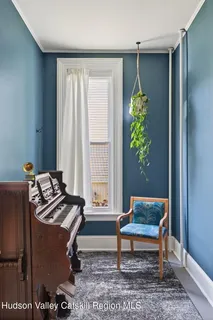 a living room with furniture a rug and a window