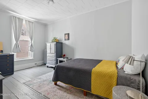 a bedroom with a bed and couch