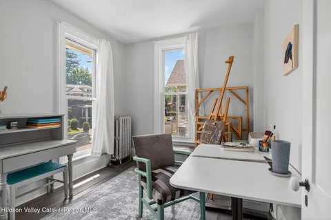 a view of a workspace with furniture and a window