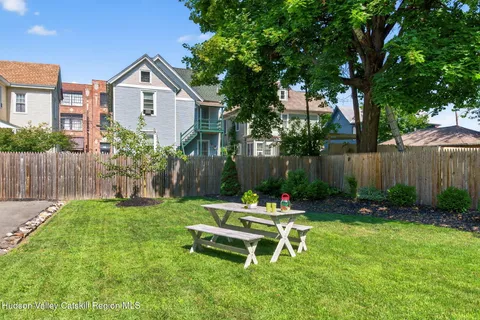 a view of a backyard with plants and trees
