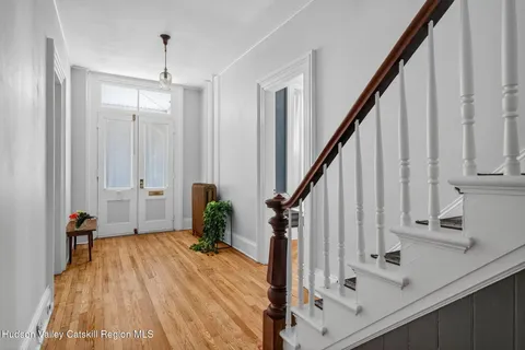 a view of entryway with wooden floor and stairs