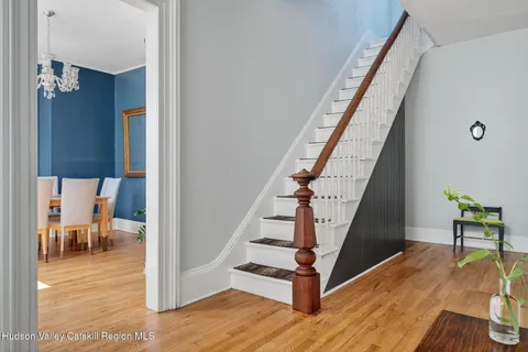 a view of entryway and hall with wooden floor