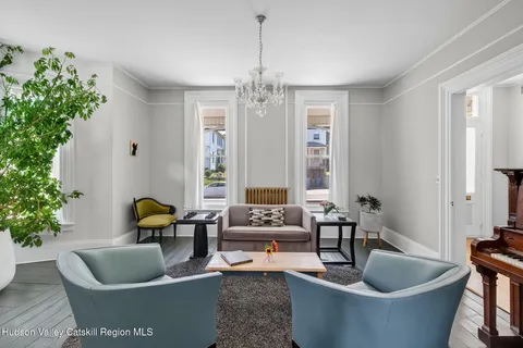 a living room with furniture and a potted plant