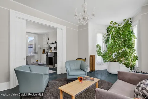 a living room with furniture and a chandelier