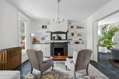 a living room with furniture fireplace and window