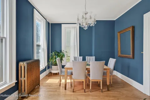 a view of a dining room with furniture window and wooden floor