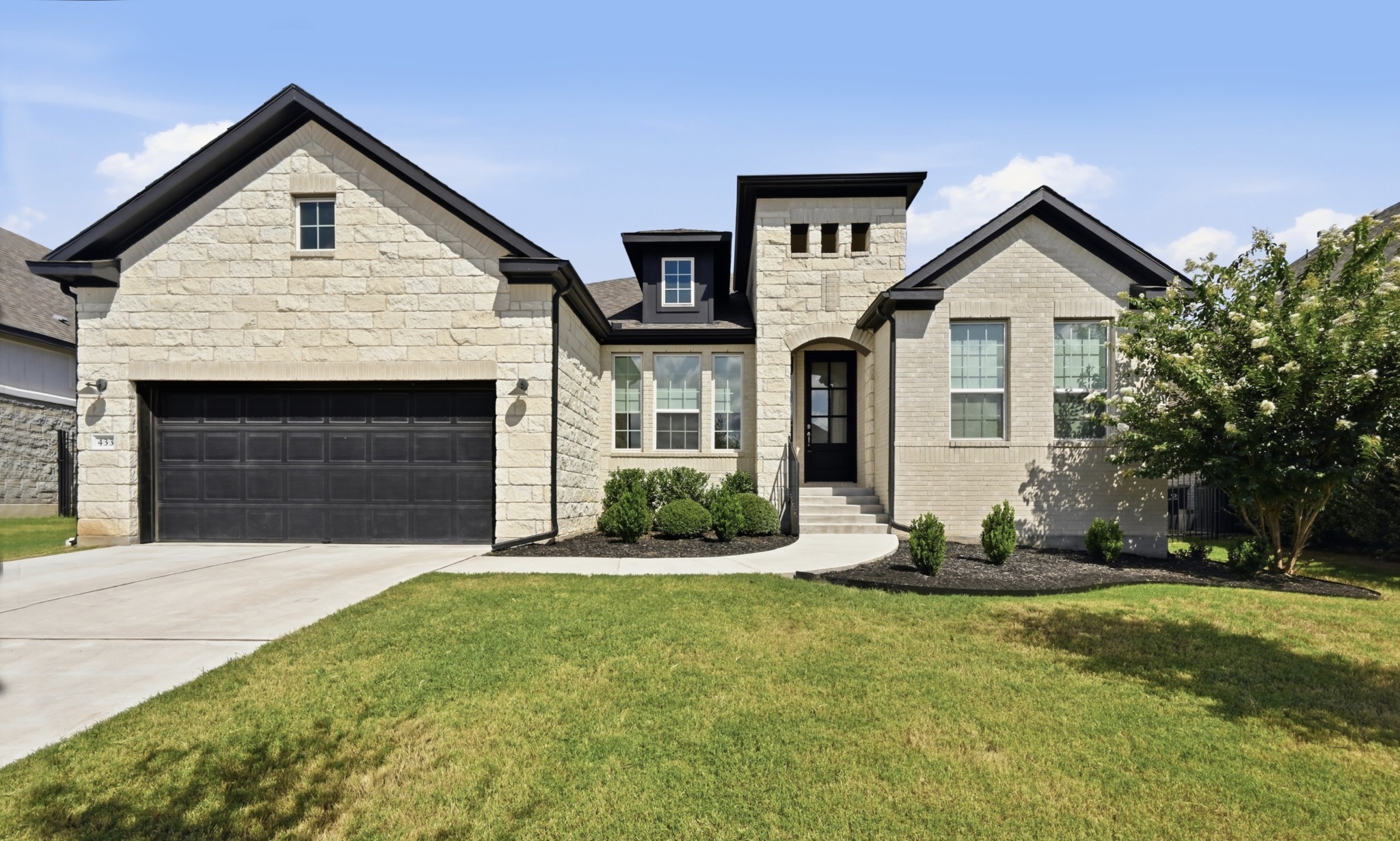 433 Running Bird Road Austin, TX 78737 - Photo 1 of 40 A well-maintained facade showcasing a harmonious blend of stone and brick.