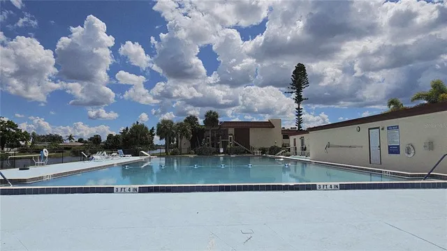 a backyard of a house with table and sofas