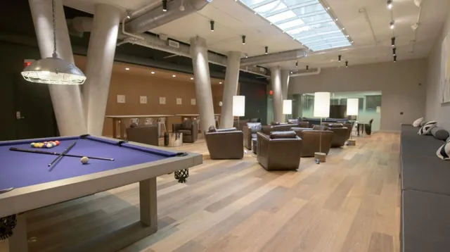 a kitchen with stainless steel appliances wooden floor dining table and chairs