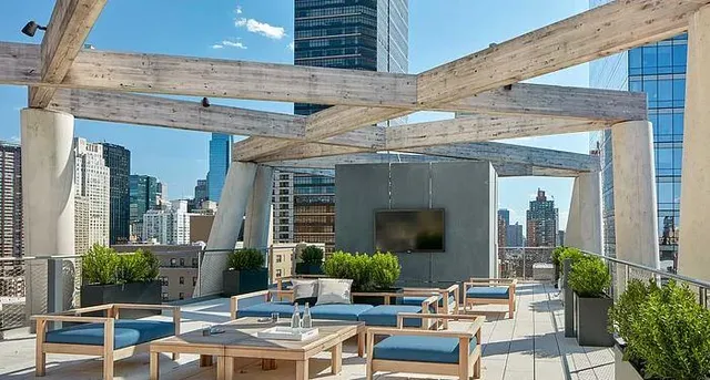 a view of a patio with couches table and chairs and potted plants