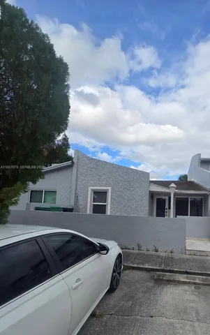 a view of multiple house with yard