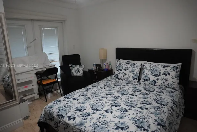 a bed room with a bed and a television