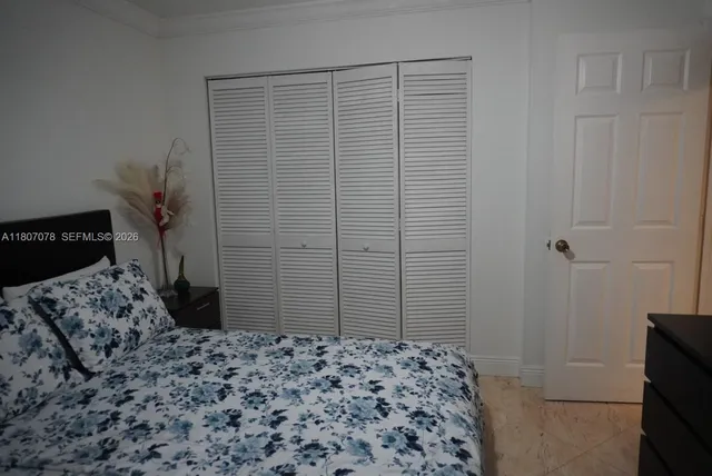a bedroom with a bed and a dresser