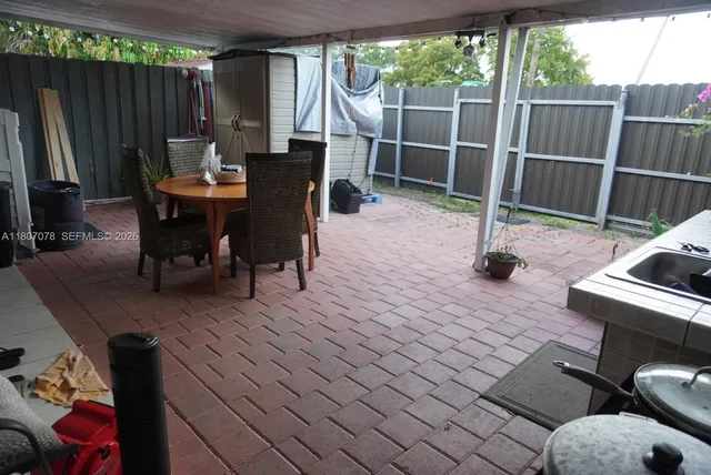 a view of a deck with table and chairs with wooden floor and fence