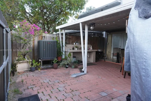a view of a house with a backyard and sitting area