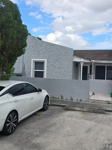 a view of a car parked in front of a house