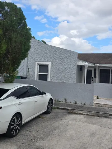 a view of a car parked front of a house