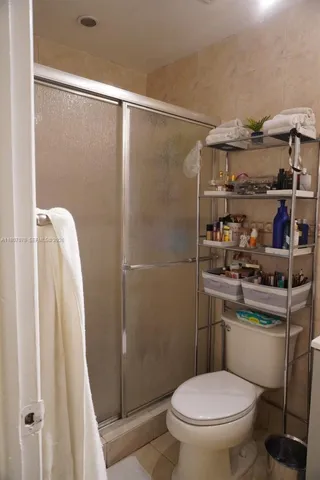 a bathroom with a toilet and a shower