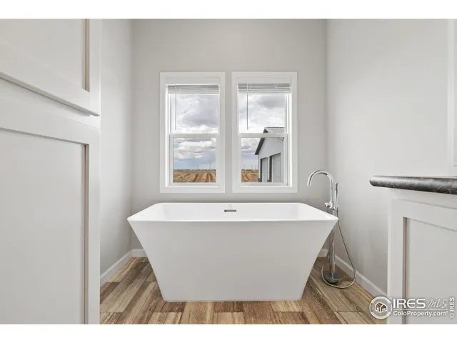 a white bath tub sitting next to a window