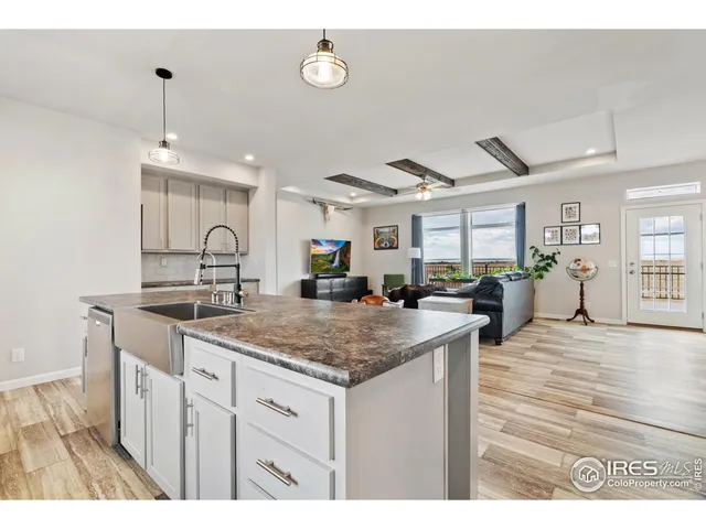 a kitchen with sink and view living room