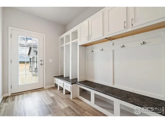 a living room with hard wood floors and a window
