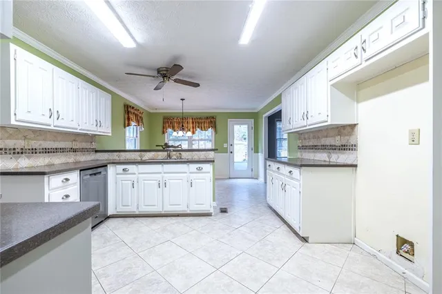 a kitchen with stainless steel appliances granite countertop a stove top oven a sink and dishwasher