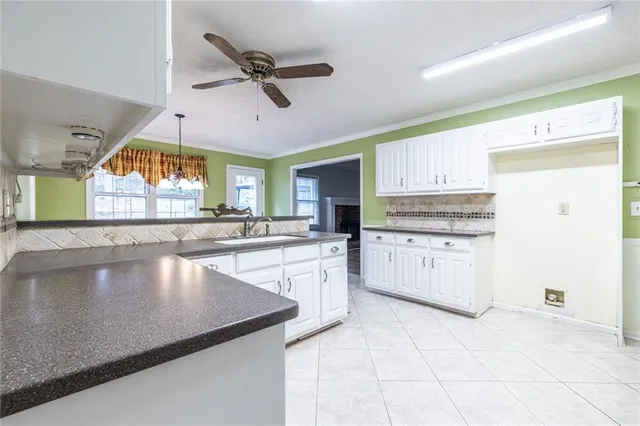 a kitchen with stainless steel appliances granite countertop a refrigerator sink and cabinets