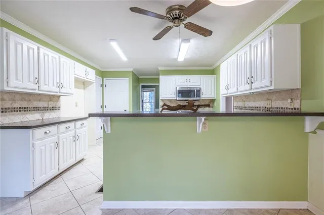 an empty room with windows fireplace and wooden floor