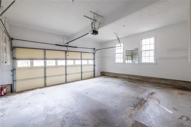 a large kitchen with granite countertop a sink and cabinets
