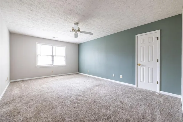 a bathroom with a granite countertop double vanity sink and a mirror